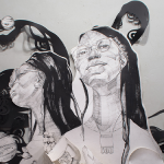 A medium-sized black and white installation with two portraits, one gazing slightly above the viewer and the other looking off into the distance facing the left.