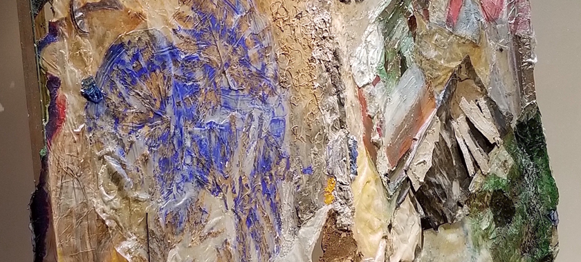 Image Detail: A torn and re-worked painting made of acrylic, acrylic media, mixed papers, wood, textiles, netting, Redbud leaves, leaves, and stems developed from a drawing and from an earlier work-in-progress that becomes a fusion of intertwining shapes of leaves with a partial figure drawing and draped acrylic pyramid at the top (not pictured).