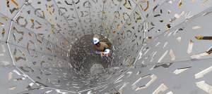 Image: Looking down into the stainless steel sculpture, we see the hard-hatted heads of two volunteers helping to build the American Riad.