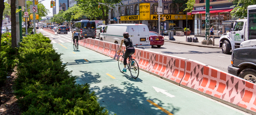 Image Detail: photo of a city street, highlighting artwork on a traffic barrier