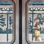 Image: Detail of a photo of Saya Woolfalk's "Urban Garden Rail" subway platform installation, as viewed through subway doors