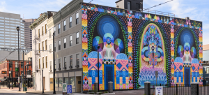 Image: Detail photograph of a colorful mural by Saya Woolfalk on the side of a building in Cincinnati, OH