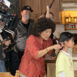 The "Lunchbox" crew films Chinluan, a Taiwanese immigrant, fixing hair of her young Taiwanese American daughter