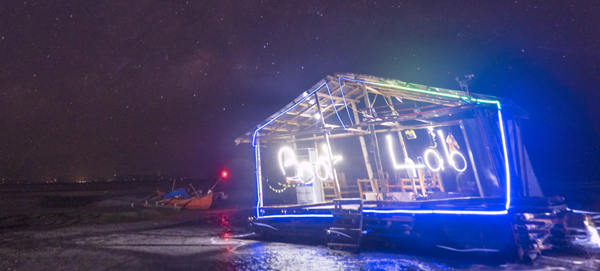 Floating raft on ocean at night with lights