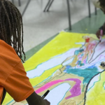 Two students working on an art project together in a ProjectArt after school class in Miami, FL