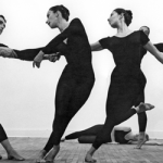 Image: Detail of a black and white photograph by Robert Rauschenberg featuring five dancers from Merce Cunningham's company in various stages of movement wearing all black.