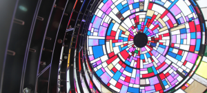 An image of a colorful stained glass watertower interior, as viewed from below