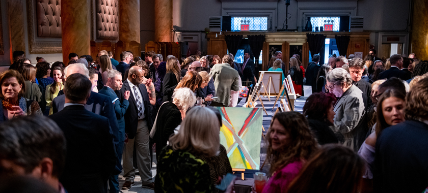 Guests enjoying the art auction during cocktail hour at NYFA's 2023 Hall of Fame Benefit