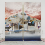 There are two large prints on canvas, depicting the shape of a mountain collaged from several photographs taken in an urban environment. The whole piece is illuminated by a studio light.