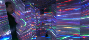 Installation by Barbara Campisi featuring screens of a semi-transparent acrylic material with small bands of neon lights across it