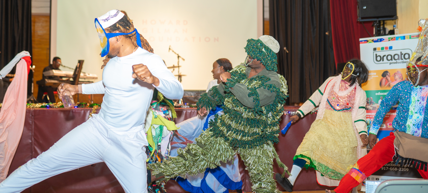 Dancers mid-movement at the Jonkanoo Parade in full flight at the annual Christmas Grand Market celebrations