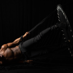 Dancer Ezra Swift photographed against a dramatic black background