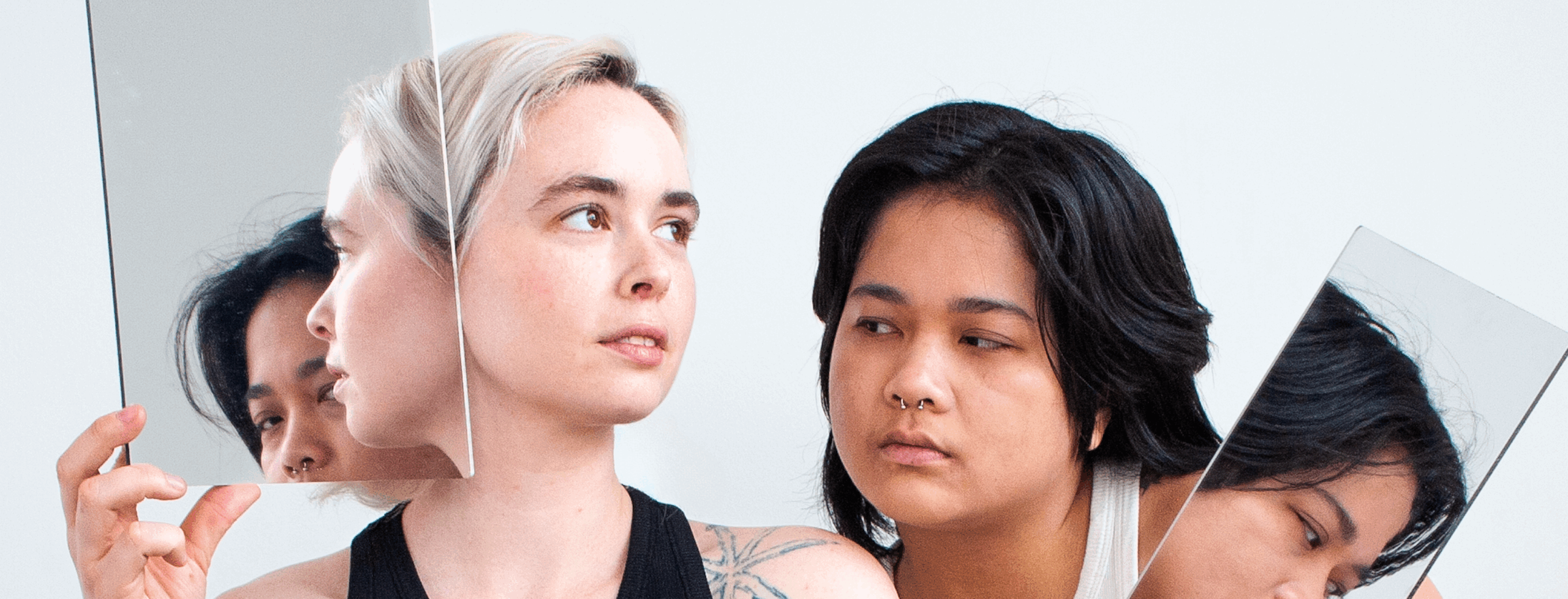 Mimi Doan and Cole Stapleton pose with mirrors in their artist photo.