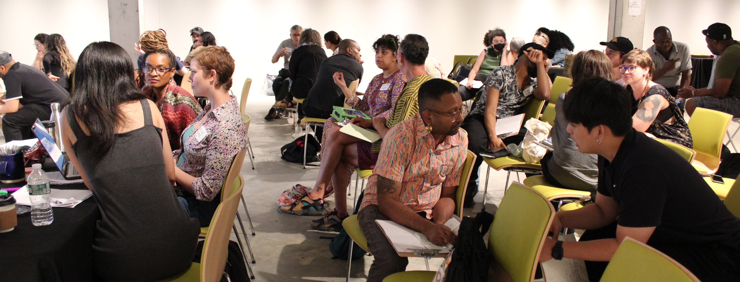 Artist as Entrepreneur participants gather at Powerhouse Arts, photographed in active conversation with each other in a learning space
