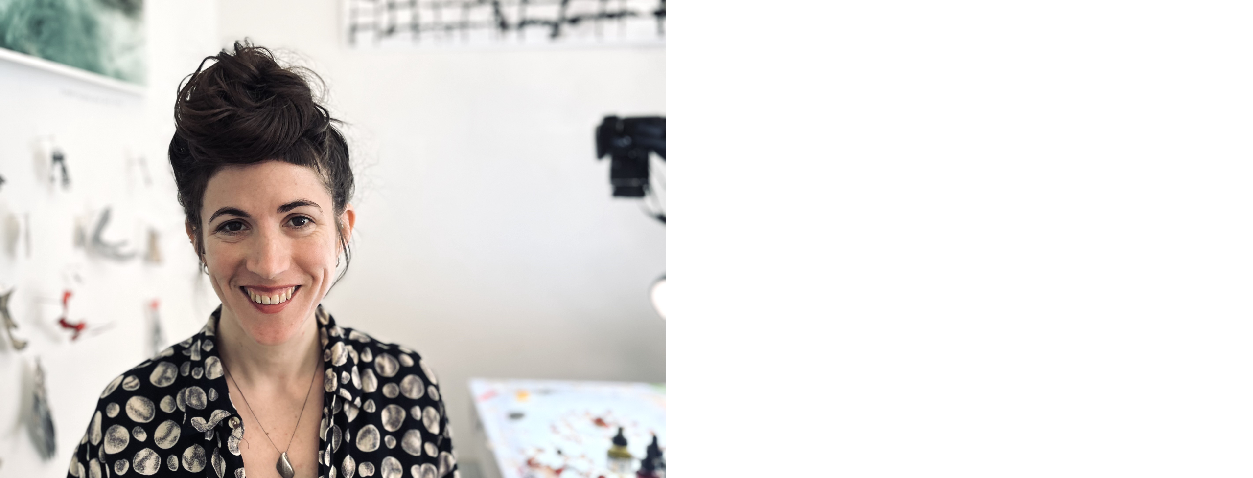 Danielle Alhassid pictured smiling at the camera in a studio setting
