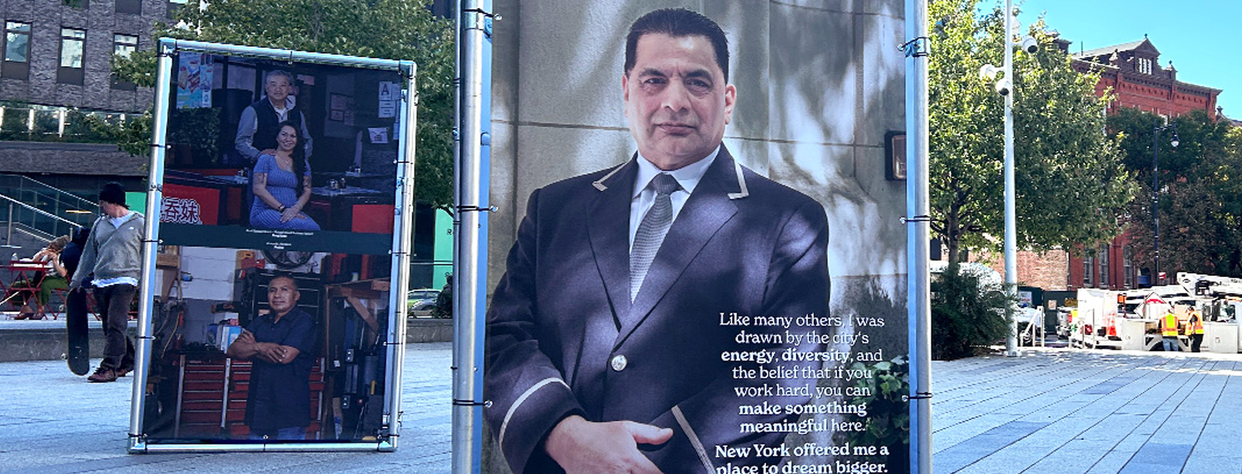 Two examples of the "New York Proud" photography campaign in a public plaza in NYC