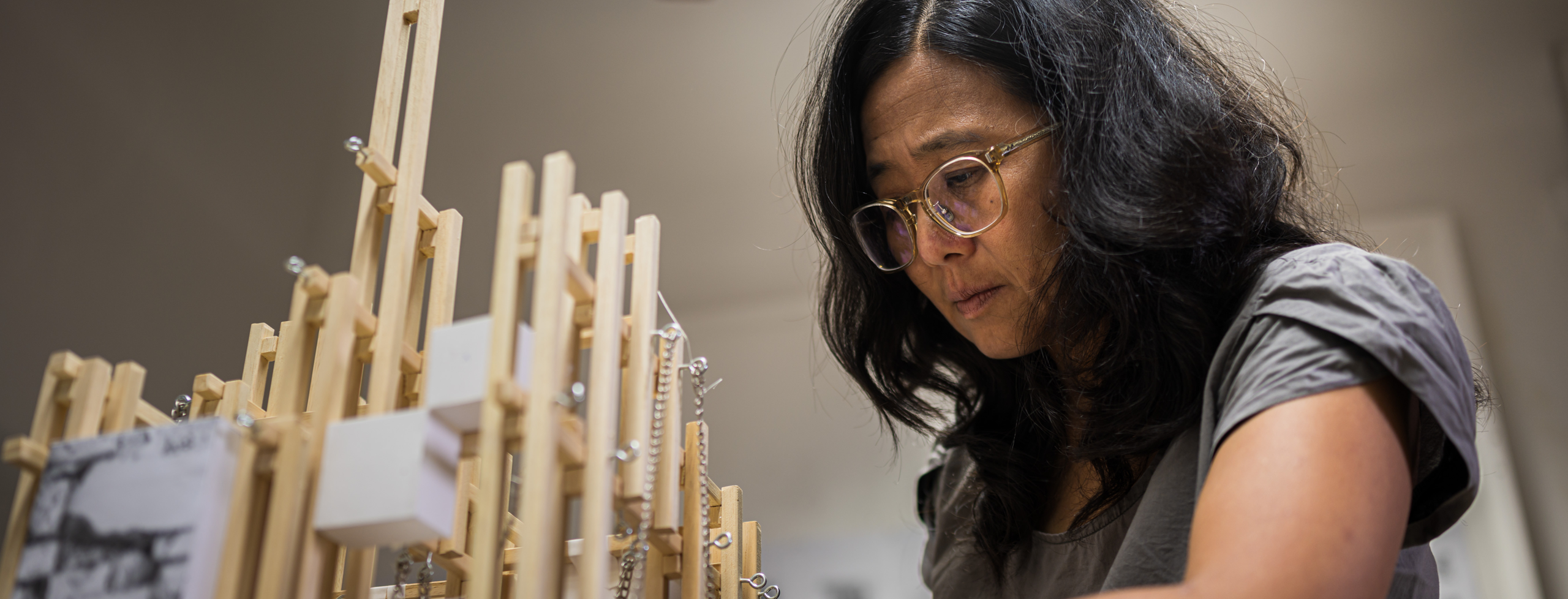 Joyce Hwang crafting a wooden framed model