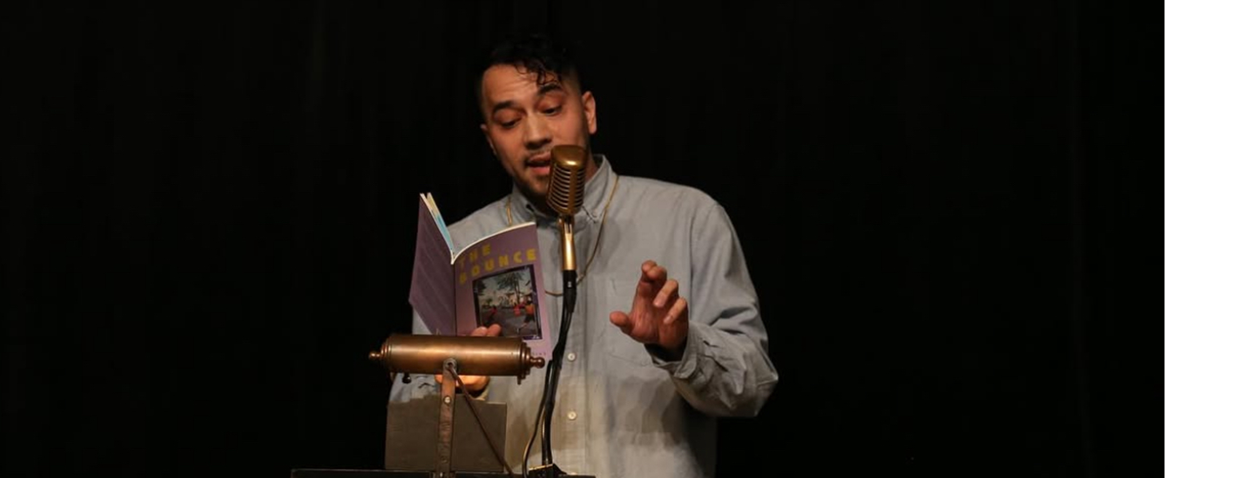 Alt Text: Karl Michael Iglesias reading poetry at Brooklyn Poets